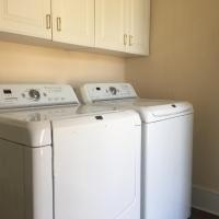 laundry room with washer, dryer, and storage
