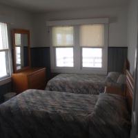 2 twin beds in bedroom with vanity dresser