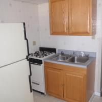 kitchen with fridge, stove, sink, and cabinets