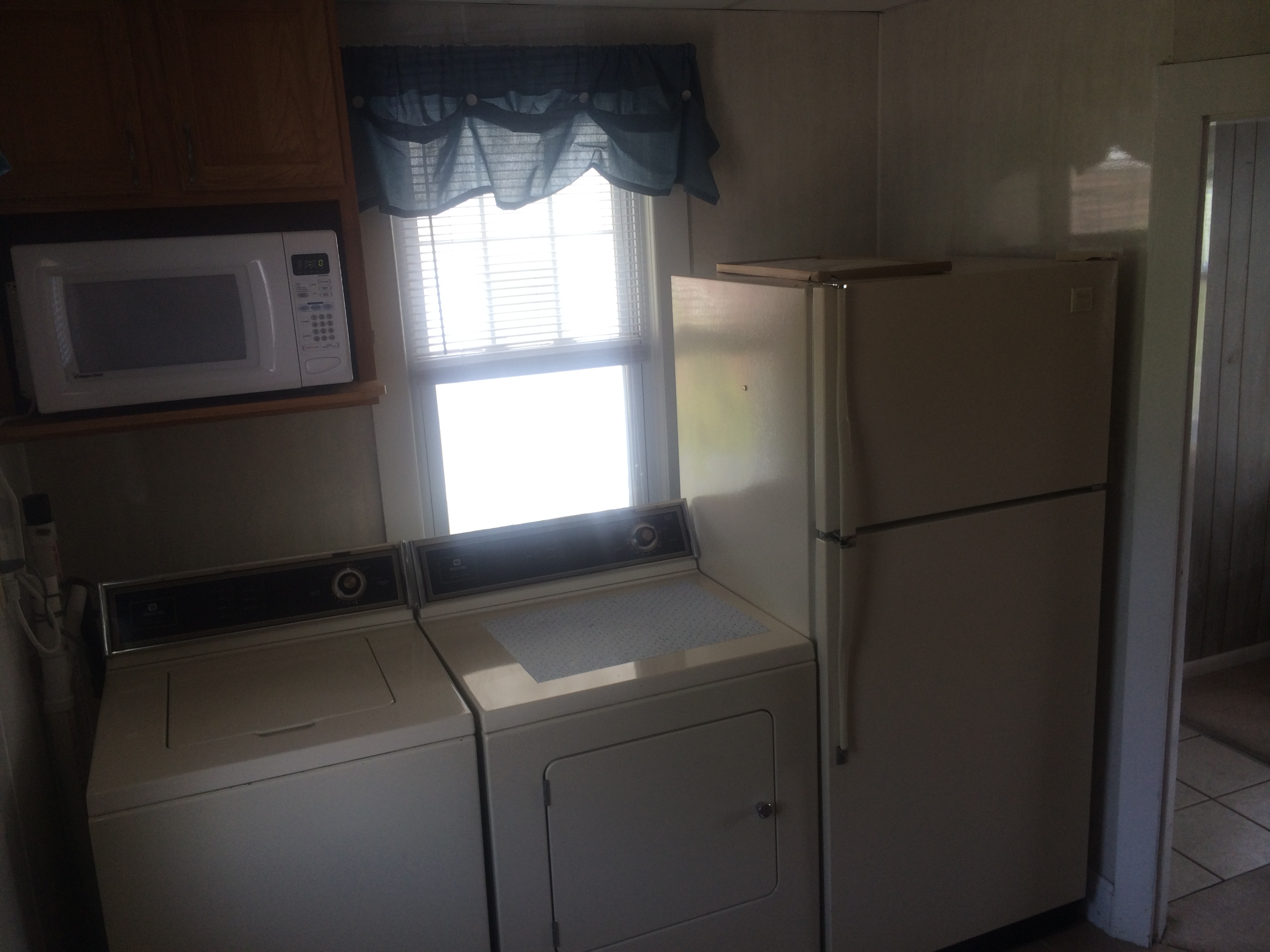 kitchen with refrigerator, washer/dryer and microwave
