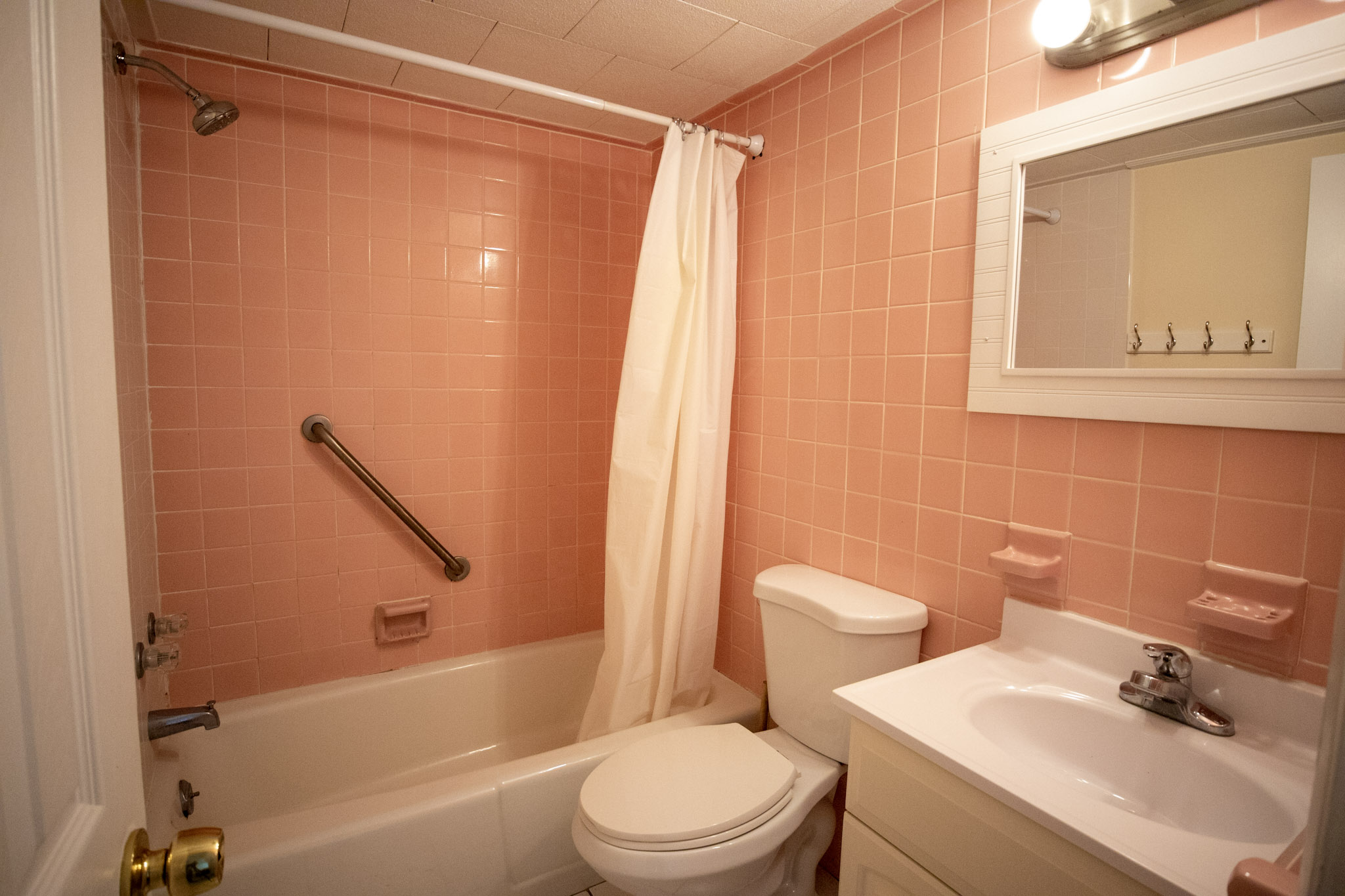 pink tile bathroom with shower and tub at the Majestic Hotel in Ocean City, Maryland