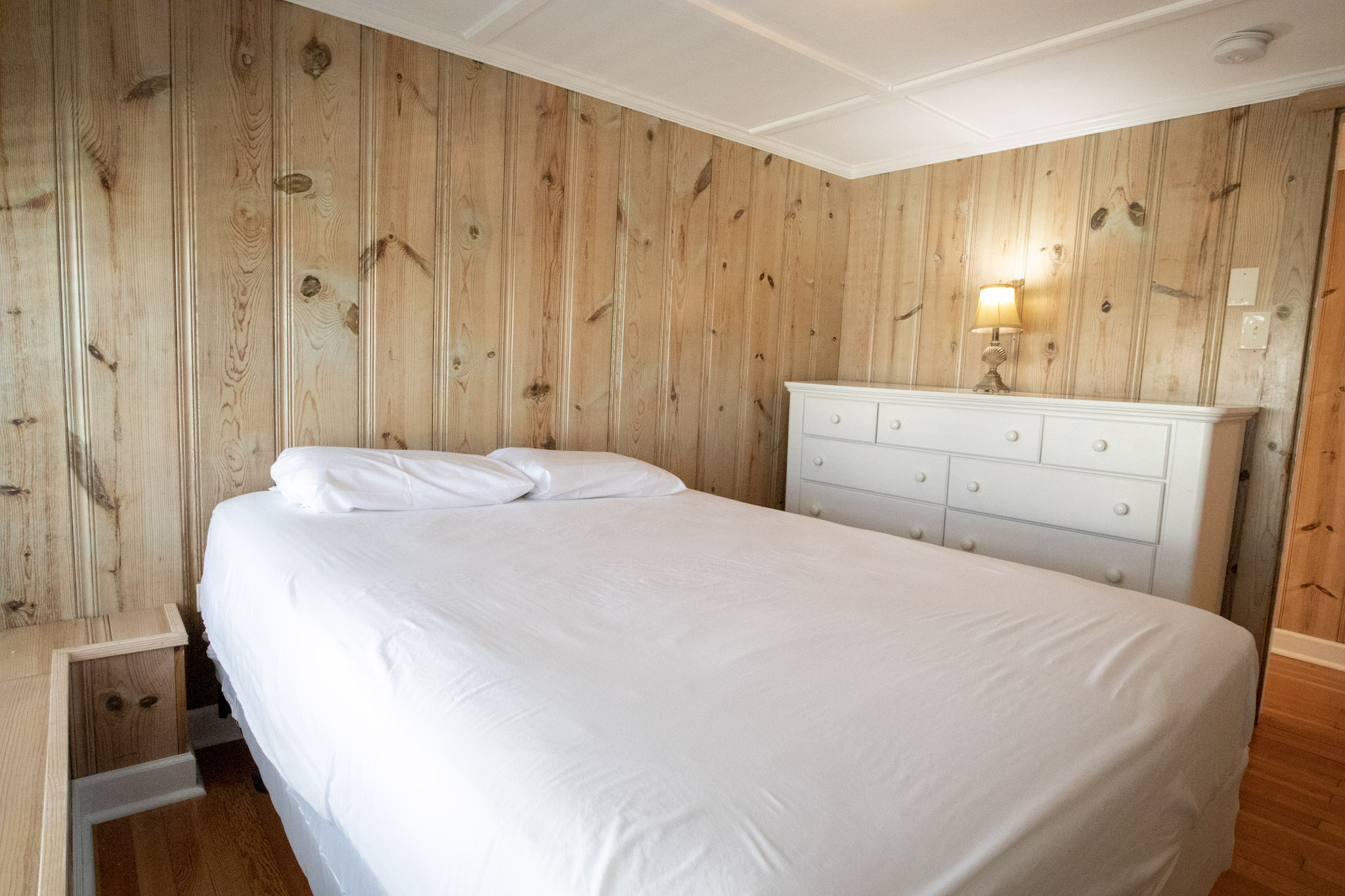 majestic hotel bedroom with queen size bed and white dresser