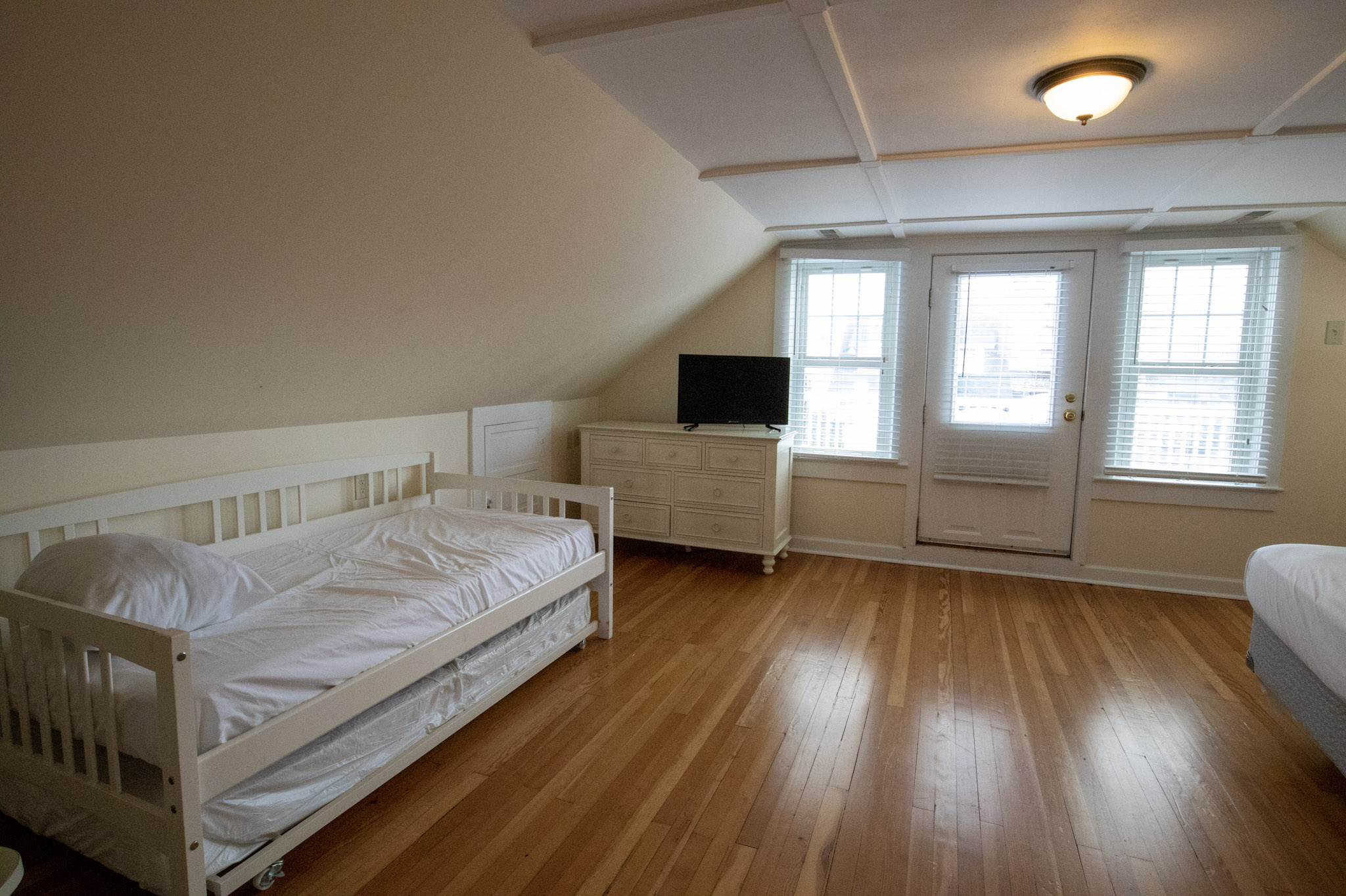 majestic hotel bedroom with trundle bed and television